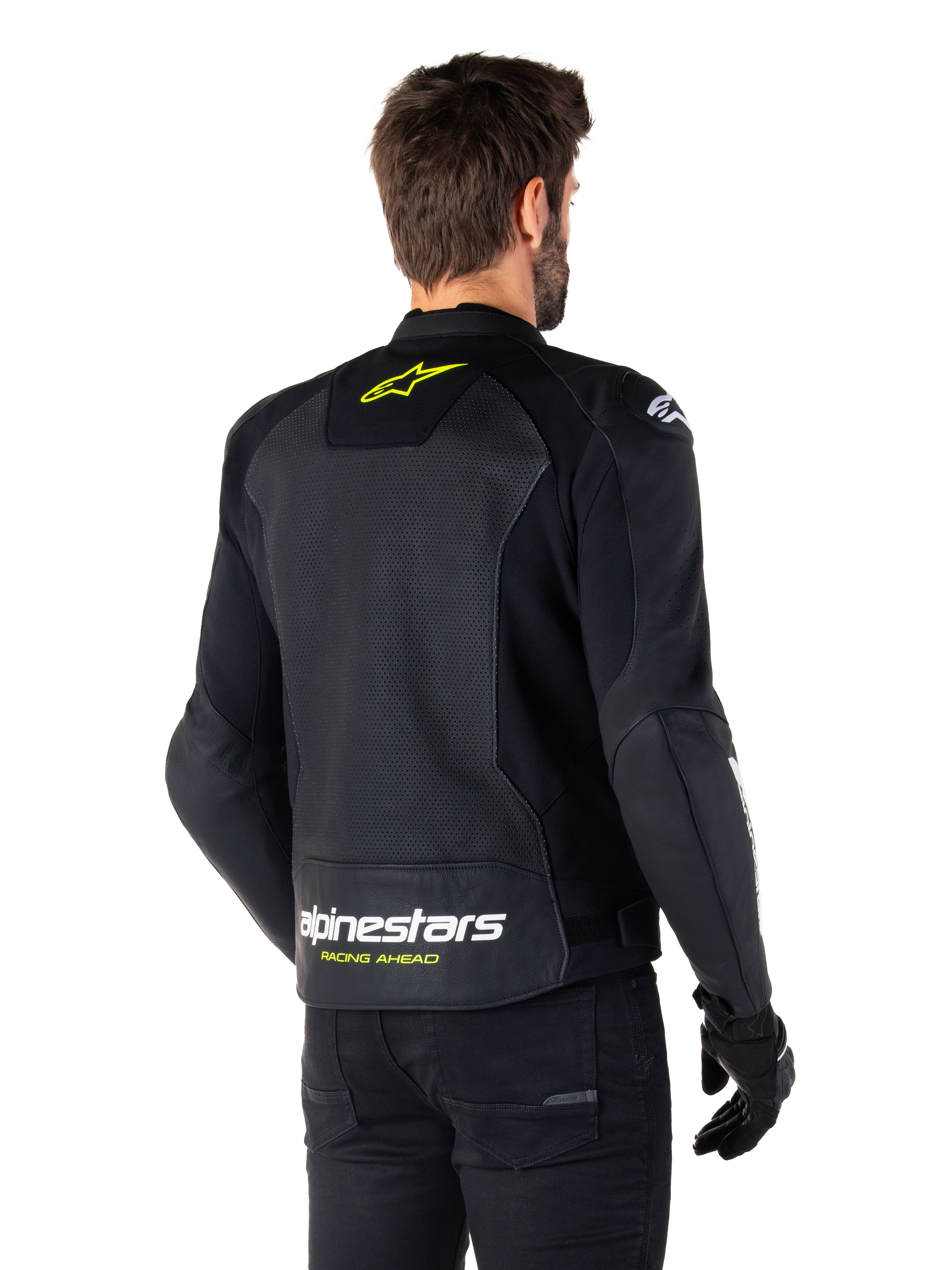 Giacca in pelle Alpinestars Faster V3 Airflow, nero, bianco e giallo fluo, vista posteriore, con un ampio pannello posteriore in pelle traforata per la ventilazione, logo a stella giallo sul colletto e marchio Alpinestars bianco con scritta 'Racing Ahead' gialla sull'orlo inferiore, abbigliamento tecnico da moto