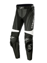 Alpinestars Stella Missile V3 Leather Pants, pantaloni moto racing da donna, nero e bianco, con pannelli a fisarmonica sopra le ginocchia, slider integrati con logo Alpinestars, dettagli bianchi e vestibilità aerodinamica per guida sportiva e in pista.