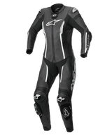 Tuta intera Alpinestars Stella Missile V2 da donna, tuta da moto racing in pelle, nero e bianco, con slider DFS su spalle e ginocchia, pannelli elasticizzati a fisarmonica e loghi bianchi evidenti, equipaggiamento professionale da pista e guida sportiva.