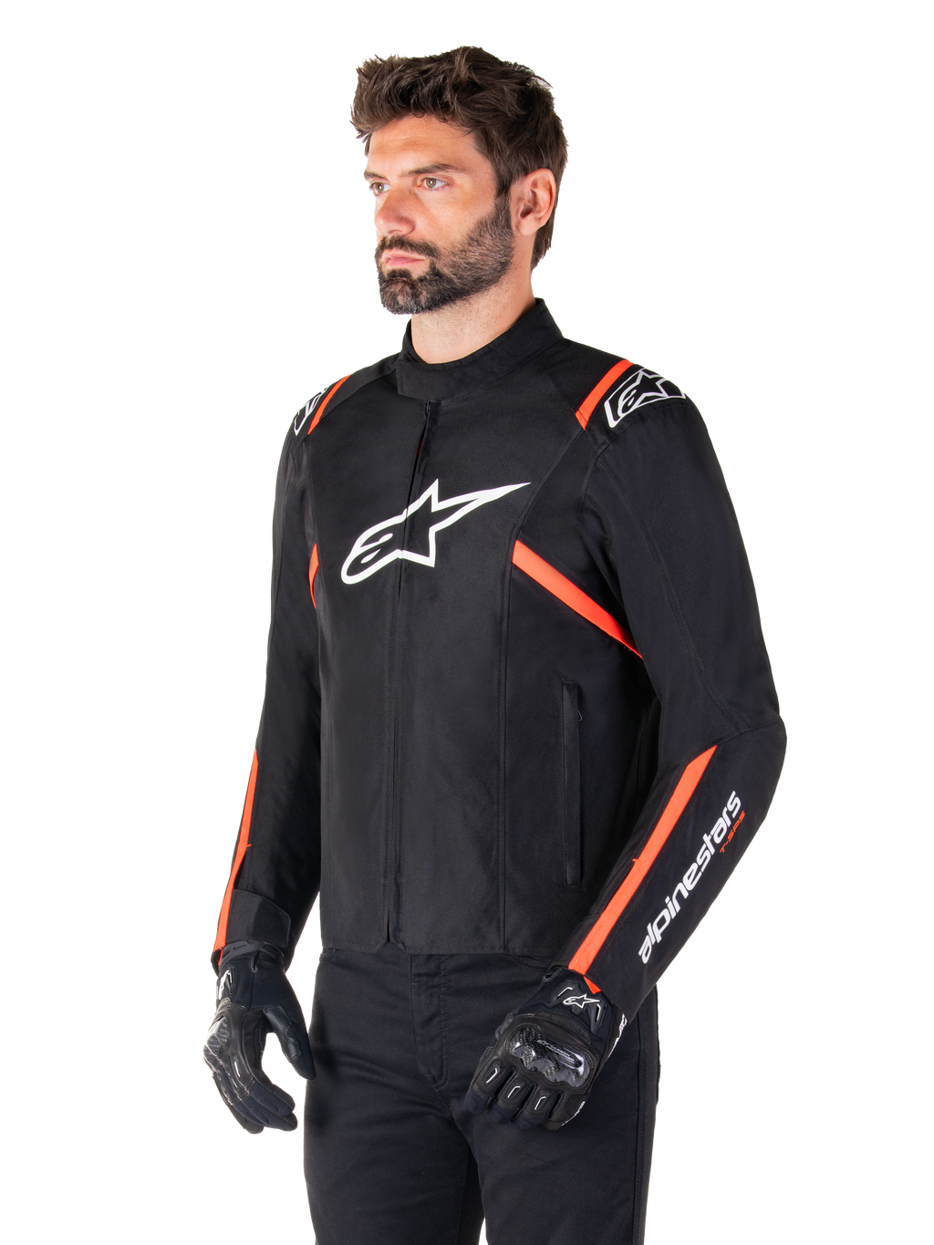 Giacca Alpinestars T-SPS V2 Waterproof, nero, bianco e rosso fluo, indossata da un modello con guanti e pantaloni neri, con un logo Alpinestars bianco sul petto e accenti rosso fluo su spalle e maniche, design sportivo in tessuto