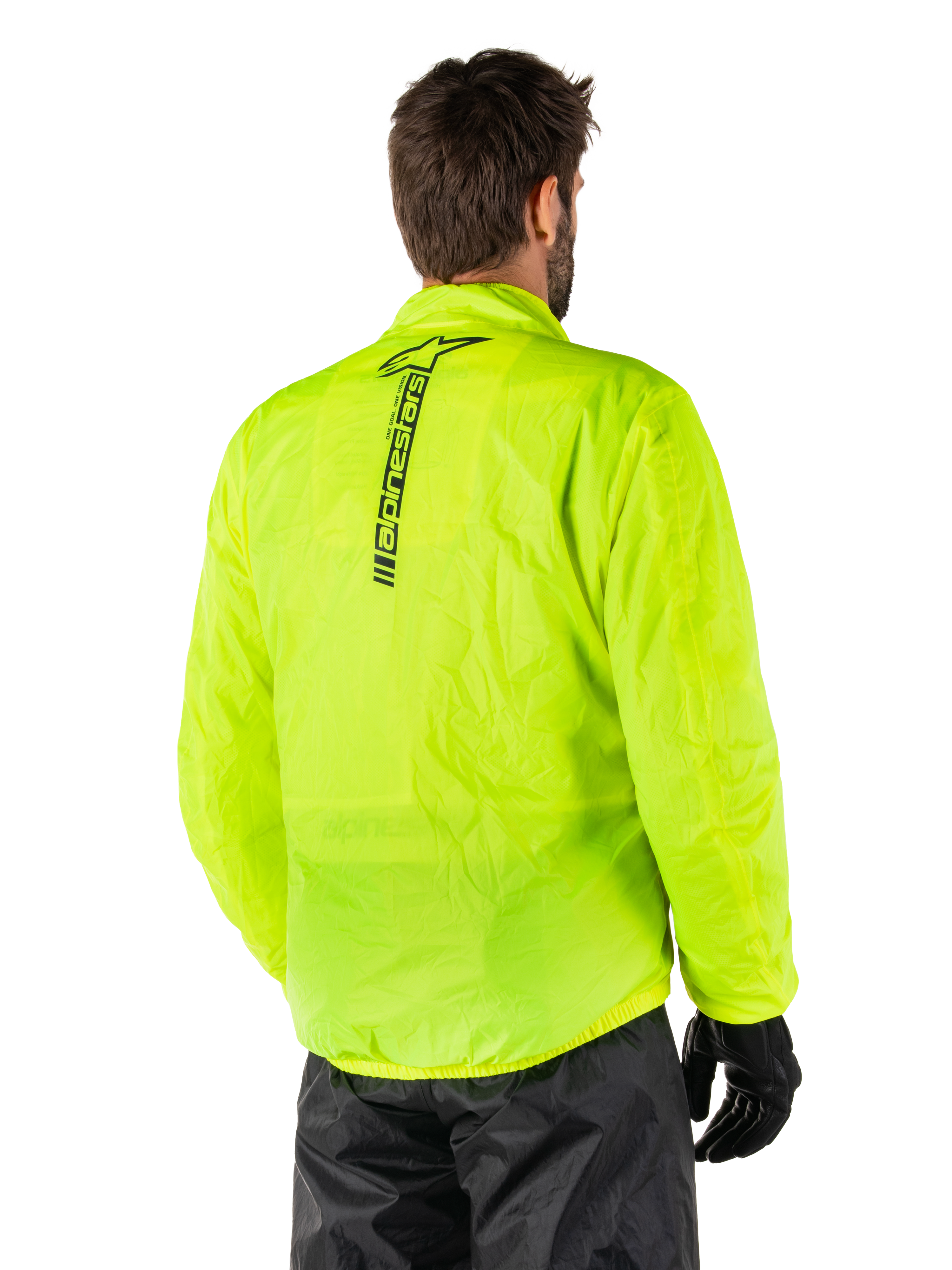 Giacca Alpinestars Hurricane Rain V2, Giallo Fluo, vista posteriore indossata da modello maschile, con marchio Alpinestars verticale nero al centro della schiena, vita e polsini elasticizzati, design impermeabile e ripiegabile