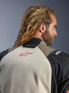Giacca Alpinestars Andes V4 Drystar®, colorazione Walnut Mastic Black, vista ravvicinata della parte superiore della schiena e del colletto, con logo a stella rosso sul pannello mastice, struttura in tessuto walnut e nero, abbigliamento per mototurismo d'avventura