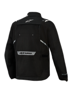 Giacca Alpinestars Cusco Drystar®, nero, vista posteriore, con logo a stella bianco sulla parte superiore della schiena, scritta Alpinestars riflettente sulla parte inferiore della schiena, ampio pannello di ventilazione con cerniera e struttura in tessuto resistente per l'adventure touring