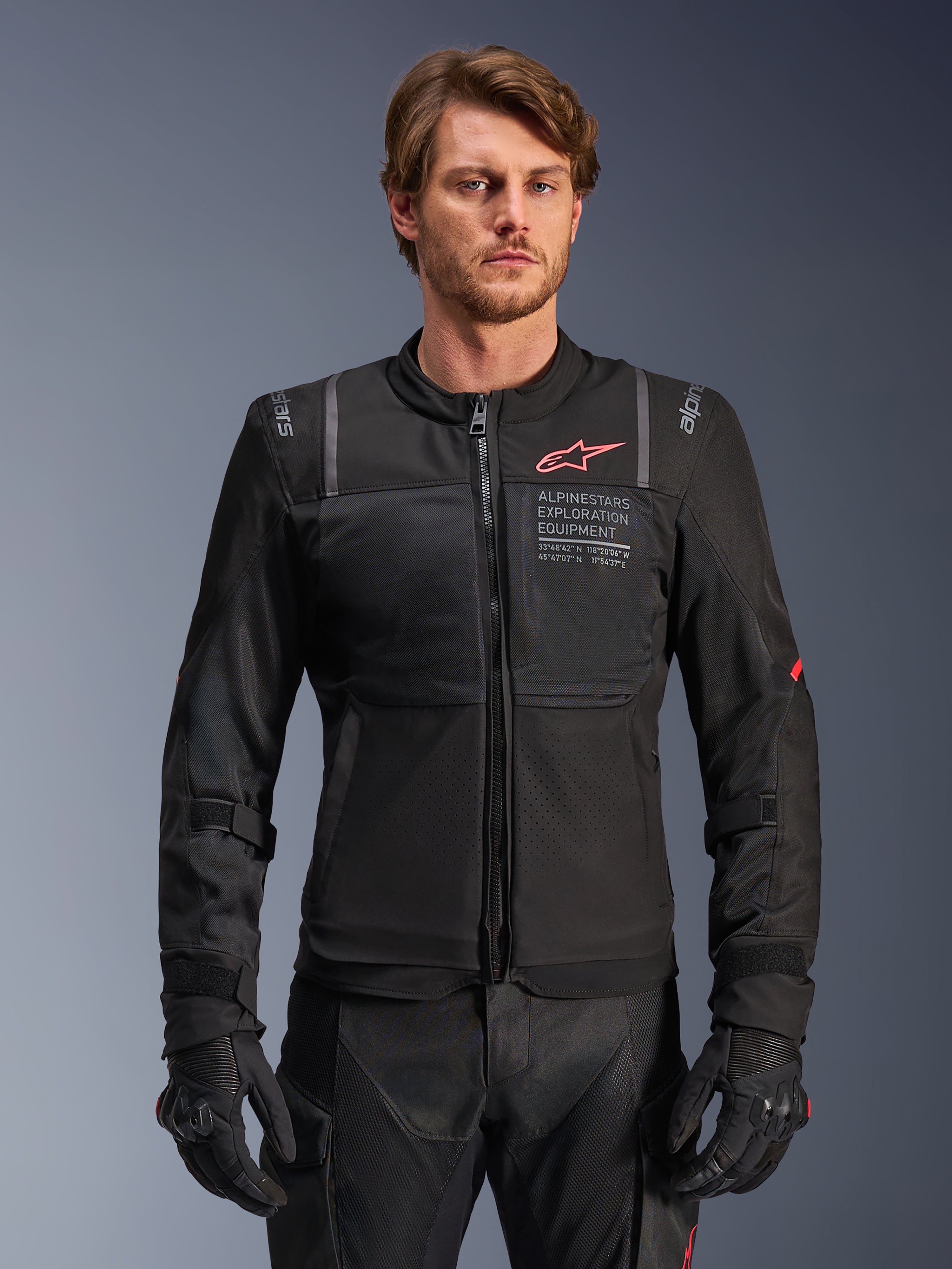 Alpinestars giacca ST-2 Air, giacca da moto touring da uomo, nera, in tessuto e mesh con logo rosso e scritta sul petto, indossata da un modello