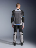 Giacca Alpinestars ST-2 Air, Ice Gray Dark Gray Black, vista posteriore su modello, con ampi pannelli di ventilazione in rete, dettagli blu e logo Alpinestars, abbinata a pantaloni da moto coordinati per adventure touring.