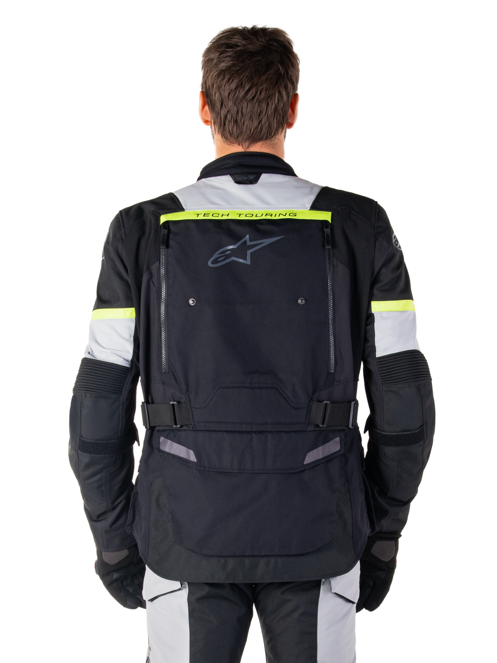 Giacca Alpinestars Bogotá Pro Drystar®, giacca da moto adventure touring, nero, grigio ghiaccio e giallo fluo, vista posteriore con branding 'TECH TOURING' su una striscia giallo fluorescente, ampio pannello di ventilazione posteriore e cinturini di regolazione in vita, abbigliamento tecnico per tutte le stagioni