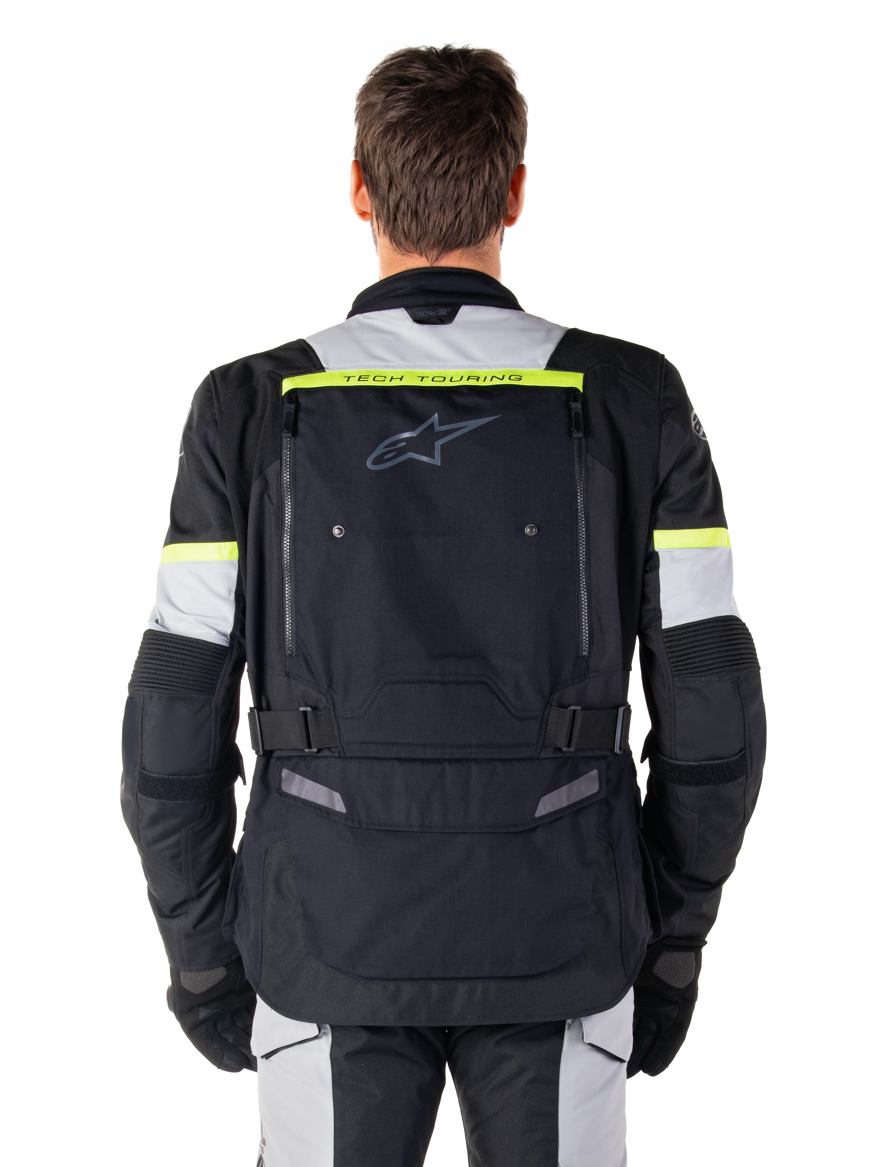 Giacca Alpinestars Bogotá Pro Drystar®, giacca da moto adventure touring, nero, grigio ghiaccio e giallo fluo, vista posteriore con branding 'TECH TOURING' su una striscia giallo fluorescente, ampio pannello di ventilazione posteriore e cinturini di regolazione in vita, abbigliamento tecnico per tutte le stagioni