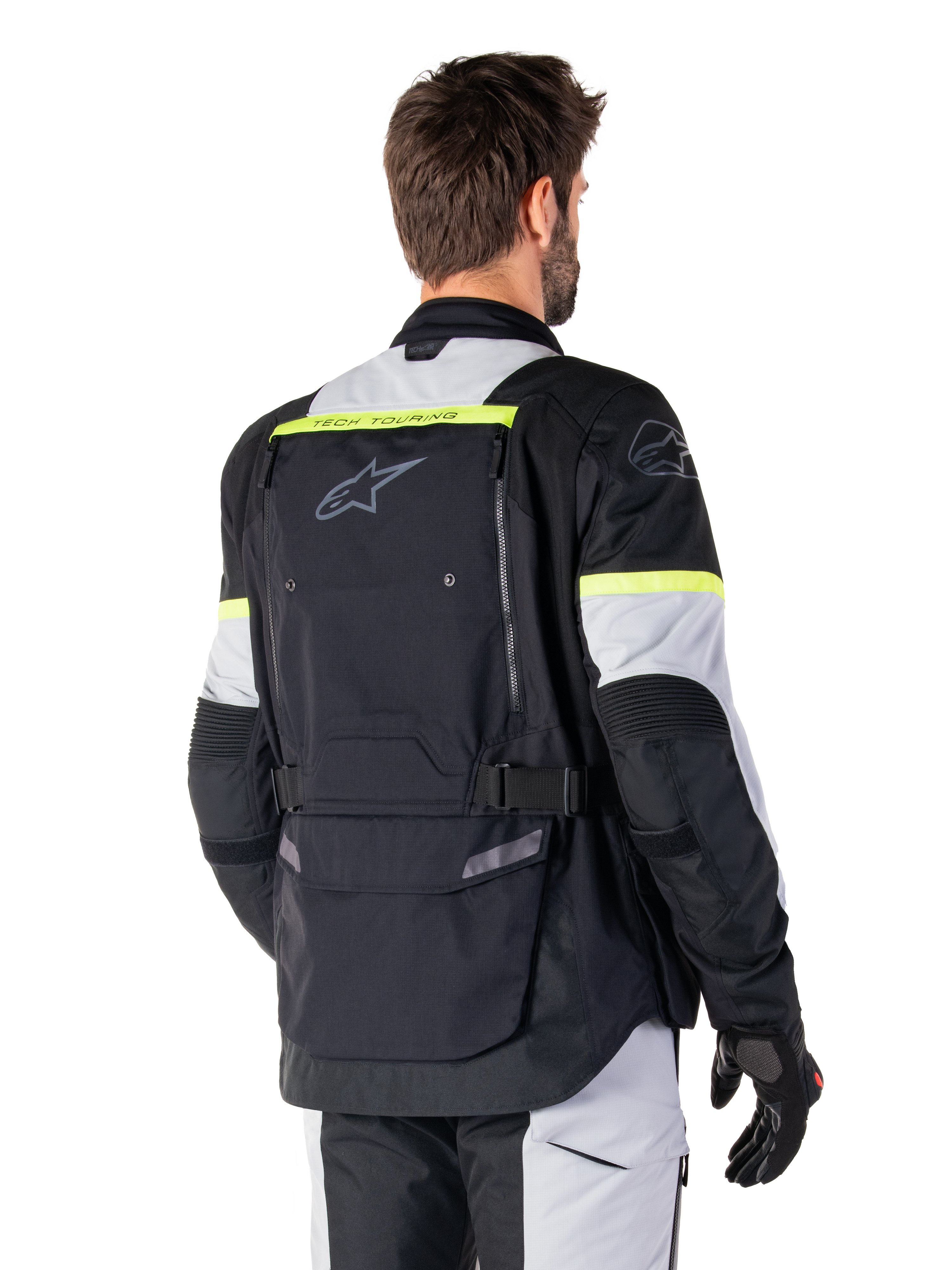 Alpinestars Giacca Bogotá Pro Drystar®, giacca adventure touring, Nero Ice Gray e Giallo Fluo, vista posteriore con ampio pannello tasca posteriore con marchio 'TECH TOURING', logo Alpinestars e accenti fluorescenti, abbigliamento tecnico in tessuto