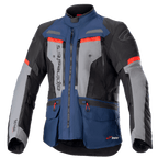 Giacca Alpinestars Bogota Pro Drystar, giacca da moto adventure touring, blu scuro e nero con pannelli grigi sul petto e dettagli rosso acceso, caratterizzata da costruzione in tessuto impermeabile, cerniere di ventilazione multiple e tasche utility.