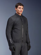 Membrana impermeabile Alpinestars Andes Air Drystar® Jacket, nero, indossata da un modello con guanti e pantaloni neri, tessuto tecnico leggero con logo 'Drystar' sulla manica, scatto in studio