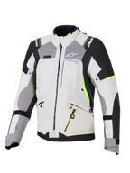 Giacca Alpinestars Stella Andes V4 Drystar®, giacca da touring avventura per donna, grigio ghiaccio e grigio scuro con accenti nero e giallo fluo, robusta struttura in tessuto con cerniere impermeabili e marchio Alpinestars, vista frontale