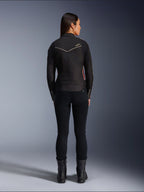 Modella vista da dietro con giacca Alpinestars Stella T-Dyno WR in Nero Rosso Brillante Fucsia, giacca da moto in tessuto con vestibilità da biker più corta, vista posteriore che mostra il logo a stella bianco, abbinata a pantaloni neri e stivali neri
