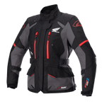 Giacca Alpinestars Stella Honda Andes V3 Drystar da donna, giacca da moto touring, nera e grigia con dettagli rosso acceso, logo Honda Wing sul petto, cerniere rosse, cinturini regolabili in vita e sulle braccia e costruzione impermeabile resistente