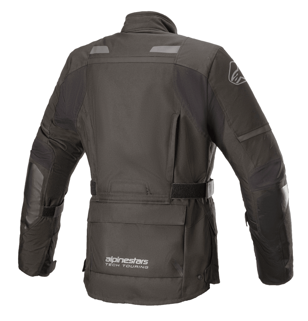 Giacca Alpinestars Stella Andes V3 Drystar® da donna, nero e grigio scuro, vista posteriore con costruzione in tessuto impermeabile, ampia tasca porta-attrezzi sul fondo schiena, cintura regolabile in vita e dettagli riflettenti di sicurezza.