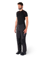 Alpinestars Hyde XT Drystar® Pants, pantaloni da moto adventure touring neri indossati da un modello con maglia a compressione nera e stivali neri, con costruzione tecnica impermeabile e marchio Drystar®XF.