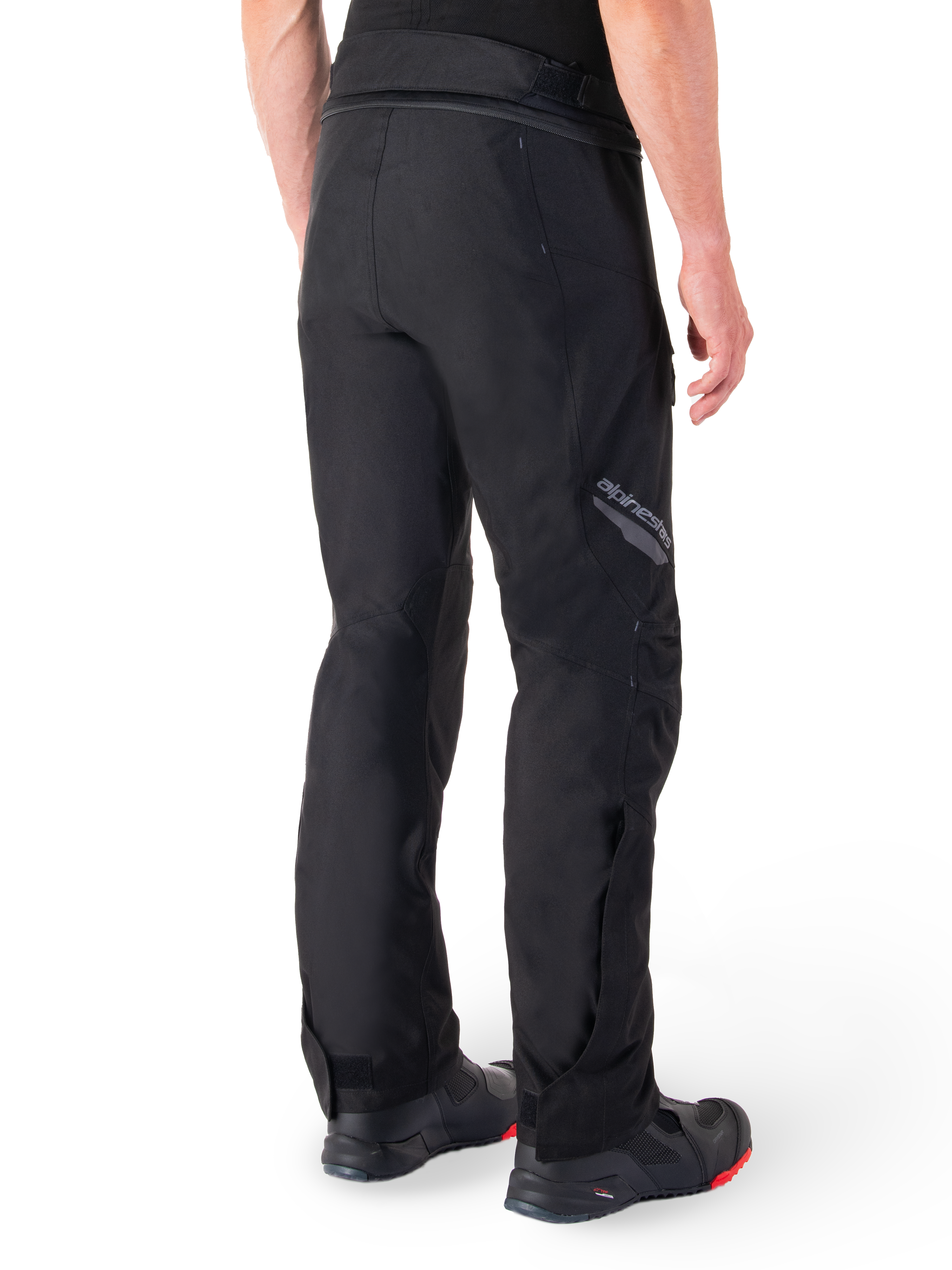 Alpinestars St-1 Waterproof Pants, Black, rear view showing textile construction and Alpinestars branding on the thigh, worn with black motorcycle boots, adventure touring style