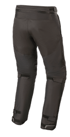 Pantaloni Alpinestars Raider V2 Drystar®, pantaloni da moto in tessuto, nero, vista posteriore che mostra la cerniera di connessione in vita e i cinturini in velcro regolabili sul retro delle gambe e delle caviglie.