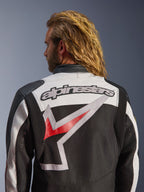 Giacca Alpinestars Axton, giacca da moto, nero, bianco avorio e rosso acceso, vista posteriore con grande logo Alpinestars ricamato e grafica stilizzata, pannelli a fisarmonica sulle spalle per la mobilità, design d'ispirazione vintage con dettagli in occhielli di metallo