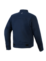 Giacca Alpinestars Bruiser, giacca da moto urbana, blu scuro, vista posteriore con costruzione in twill di policotone elasticizzato, piccolo logo bianco sul retro del collo, occhielli di ventilazione sulle maniche e linguette di regolazione in vita.