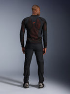Alpinestars Giacca Troop-Air Pro in Black Red Fluo, vista posteriore su modello, giacca tecnica in mesh con protezioni e pannelli traspiranti, logo rosso sulla parte superiore della schiena, indossata con pantaloni neri e sneaker, abbigliamento motociclistico urbano