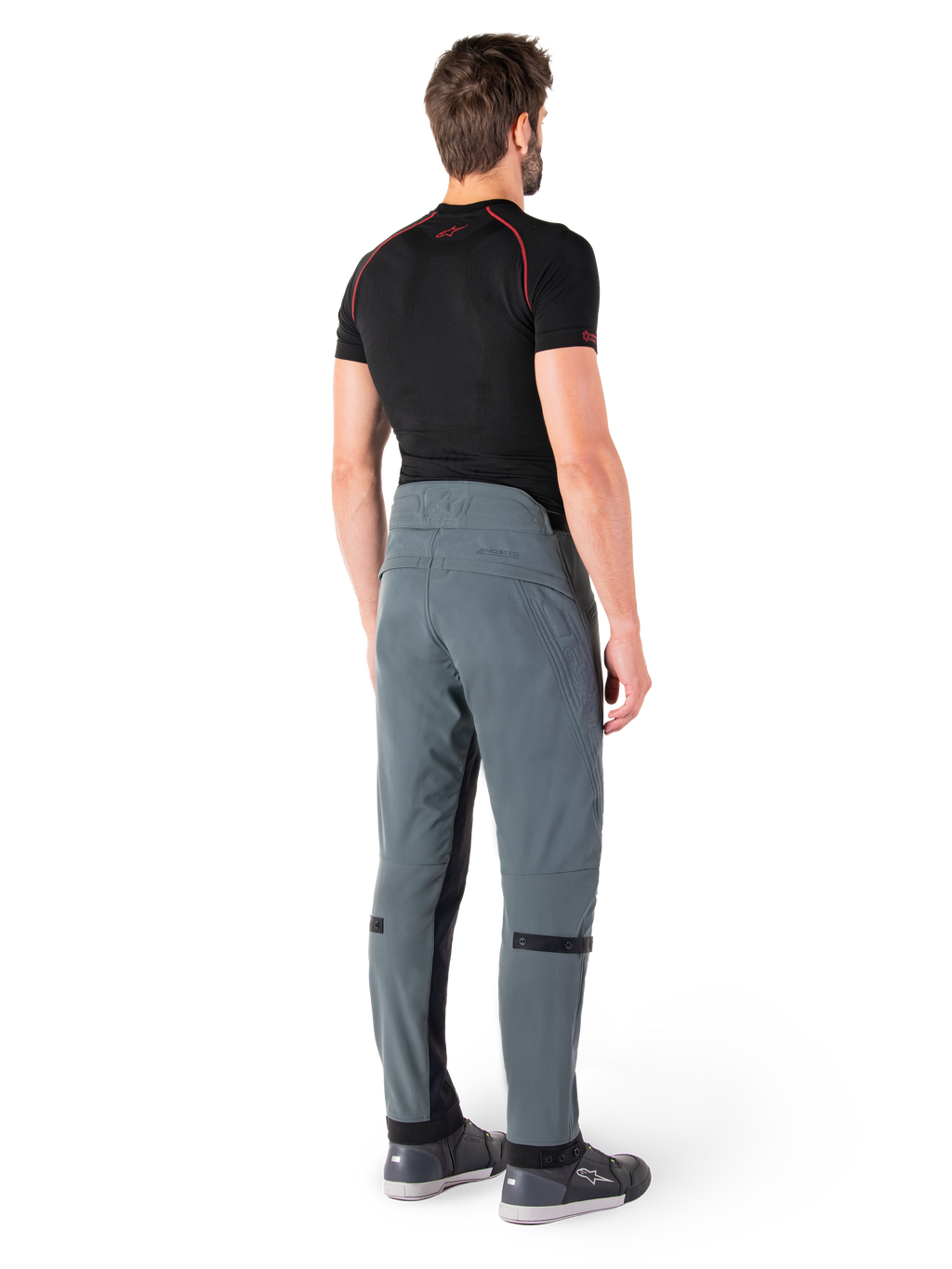 Alpinestars Alden Pants, Urban Gray, vista posteriore, pantaloni da moto in tessuto tecnico con dettagli trapuntati sulla parte superiore della vita posteriore e sulle gambe, abbinati a un base layer nero e scarpe da moto grigie, stile streetwear urbano contemporaneo