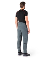 Alpinestars Alden Pants, Urban Gray, vista posteriore, pantaloni da moto in tessuto tecnico con dettagli trapuntati sulla parte superiore della vita posteriore e sulle gambe, abbinati a un base layer nero e scarpe da moto grigie, stile streetwear urbano contemporaneo