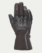 Guanti Alpinestars Stella Tourer W-7 Drystar® da donna, nero, guanto da moto invernale a polsino lungo con costruzione in pelle e softshell, protezione rigida delle nocche ricoperta in pelle, dettagli argento riflettenti e logo Alpinestars sul dito.