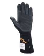 Guanti Alpinestars Tech-1 ZX V4, guanti per auto racing, nero e arancione fluo, vista del palmo che mostra il pattern di grip in silicone 3D e la trama a nido d'ape, etichette di omologazione FIA e SFI visibili sul polsino, attrezzatura professionale per motorsport