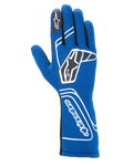 Guanti Alpinestars Tech-1 Start V4 FIA, guanti da corsa automobilistica, blu Royal, con branding geometrico bianco e loghi a stella neri, polsino allungato con scritta Alpinestars in verticale, elegante struttura senza cuciture per prestazioni leggere, attrezzatura da corsa professionale certificata FIA