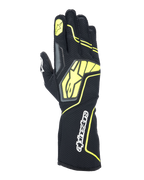 Guanti Alpinestars Tech-1 KX V4, guanti da karting, grigio tar, nero e giallo fluo, vista del dorso con struttura in mesh traspirante, grande logo Alpinestars giallo, scritta bianca sul polso, stella gialla sull'indice, design sportivo moderno