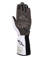 Guanti Alpinestars Tech-1 KX V4, guanti da kart, bianco, nero e oro, vista del palmo che mostra il pattern di grip in silicone 3D, costruzione in mesh bianco traspirante ed etichetta di certificazione FIA 8877-2022 sul polsino.