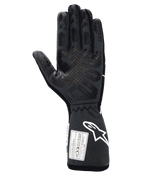 Guanti Alpinestars Tech-1 Race V4, guanti professionali da corsa auto, nero e grigio, vista del palmo con estese stampe in silicone per il grip su dita e palmo, polsino allungato con logo Alpinestars bianco ed etichette di certificazione FIA/SFI