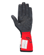Guanti Alpinestars Tech-1 Race V4, guanti da auto racing, nero e rosso, vista del palmo con motivi grip in silicone su dita e palmo, polsino rosso esteso con logo Alpinestars ed etichetta di certificazione FIA, equipaggiamento motorsport ad alte prestazioni