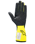 Guanti Alpinestars Tech-1 Race V4, guanti da corsa auto, nero e giallo fluo, vista del palmo con grip in silicone testurizzato, polsino giallo esteso con etichetta di certificazione FIA, equipaggiamento motorsport ad alte prestazioni