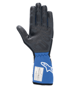 Guanti Alpinestars Tech-1 Race V4, nero e blu, vista interna del palmo con motivo grip in silicone testurizzato, polsino blu esteso con etichetta di certificazione FIA e logo Alpinestars bianco, attrezzatura professionale per corse automobilistiche