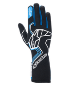 Guanti Alpinestars Tech-1 Race V4, guanti da corsa automobilistica, nero con dettagli blu e bianchi, con un grande logo bianco sul dorso, profili blu sulle dita e polsino lungo, design professionale ignifugo per motorsport