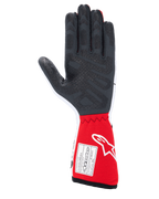 Guanti Alpinestars Tech-1 Race V4, guanti da auto racing, bianco e rosso, vista del palmo con motivi grip in silicone nero testurizzato e etichetta di certificazione FIA 8856-2018 sul polsino esteso rosso, equipaggiamento professionale per motorsport