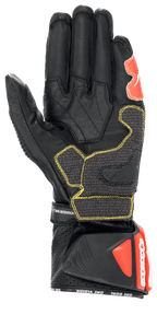 Guanti Alpinestars GP Tech V2, nero, bianco e rosso fluo, vista del palmo con costruzione in pelle nera e cuciture gialle a contrasto, polsino protettivo DFS con dettagli rossi, equipaggiamento professionale da corsa per moto