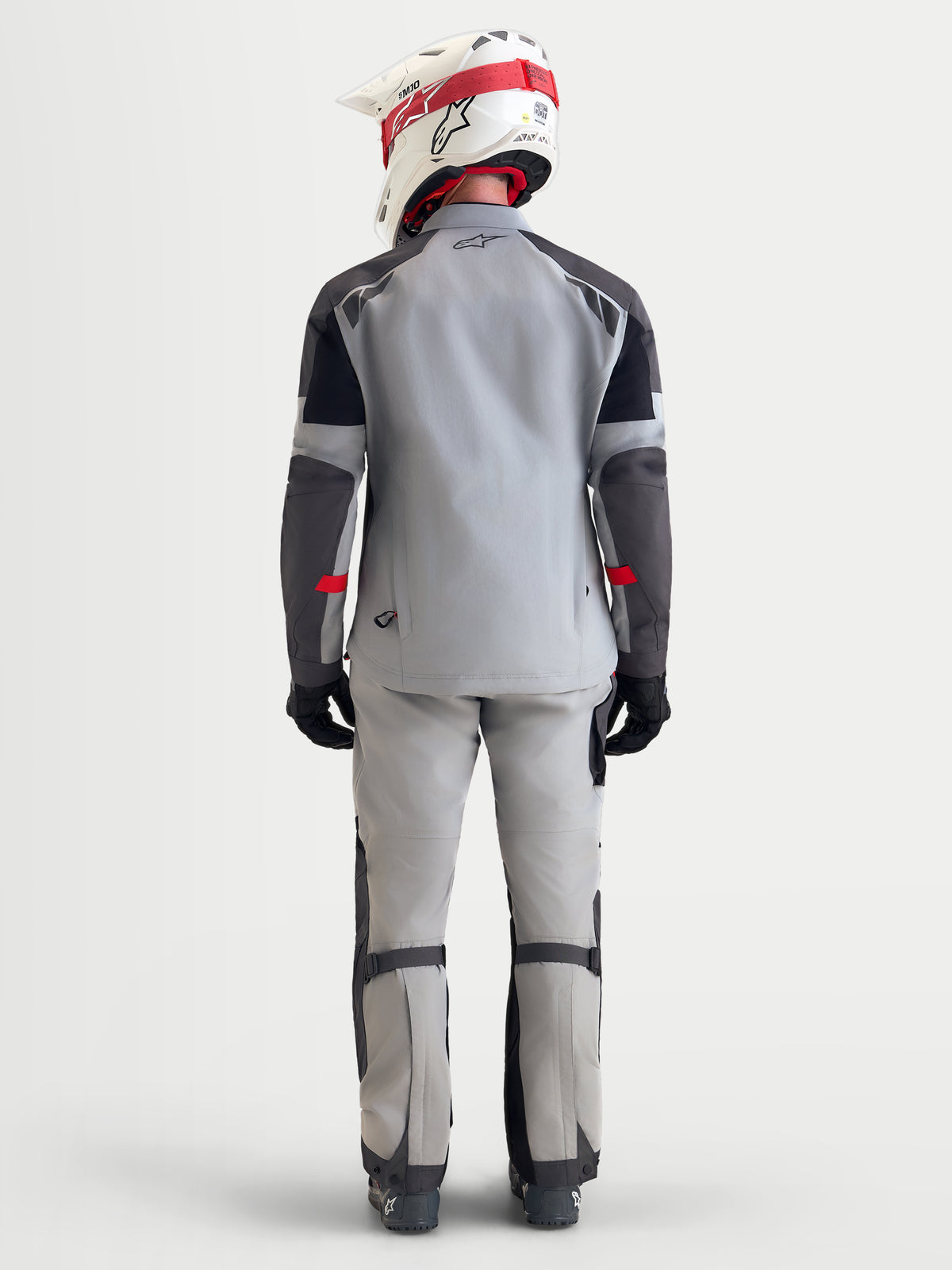 Alpinestars Arenis Gore-Tex Gear Set, completo da moto adventure da uomo in grigio chiaro, grigio scuro e nero, vista posteriore su un modello che indossa casco e abbigliamento coordinati