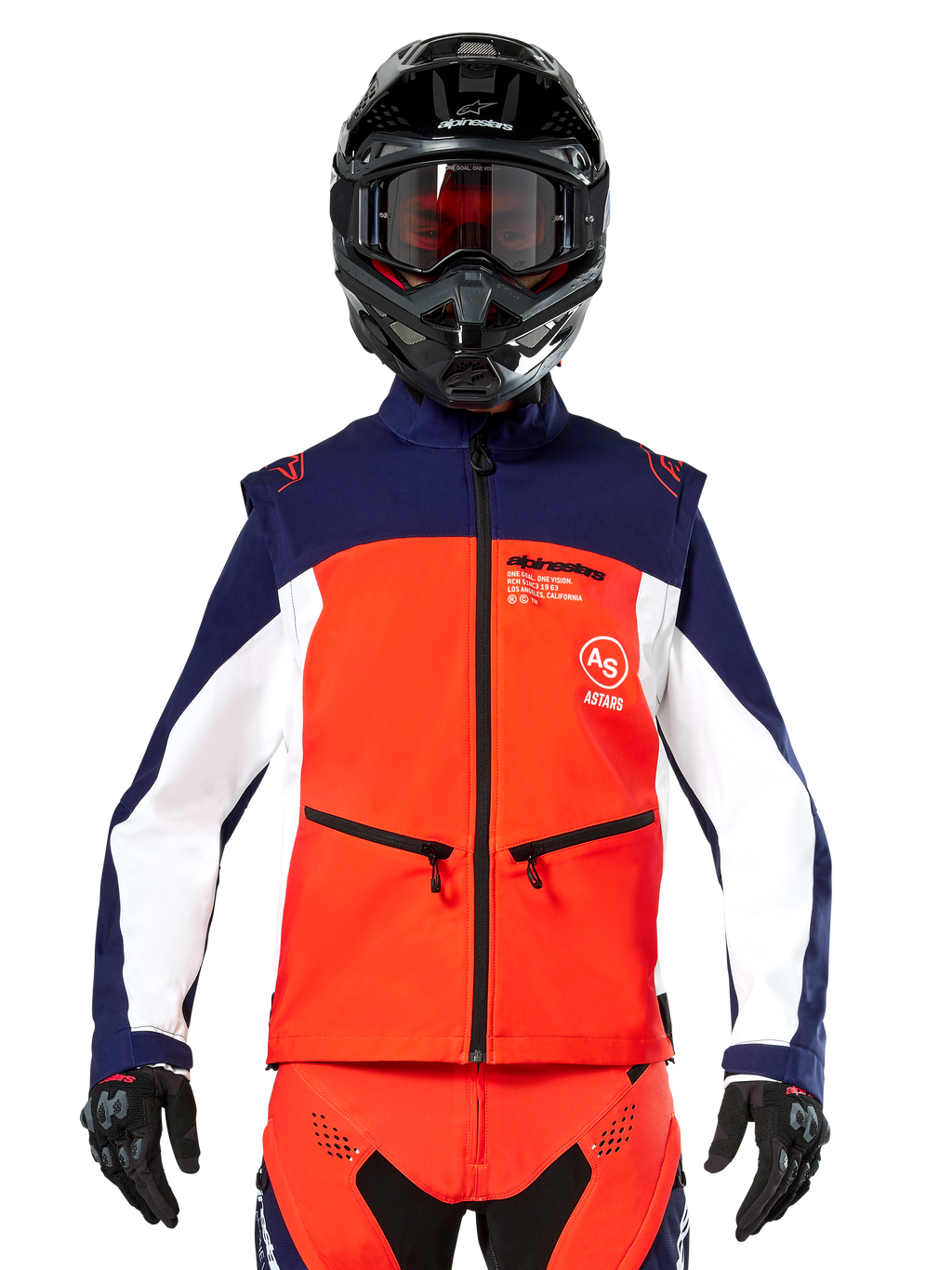 Giacca Softshell Alpinestars Lite-Dura in blu navy, arancione acceso e bianco, vista frontale su un pilota con casco nero e maschera, design tecnico color-block con tasche con zip e logo Alpinestars, attrezzatura versatile per enduro e fuoristrada