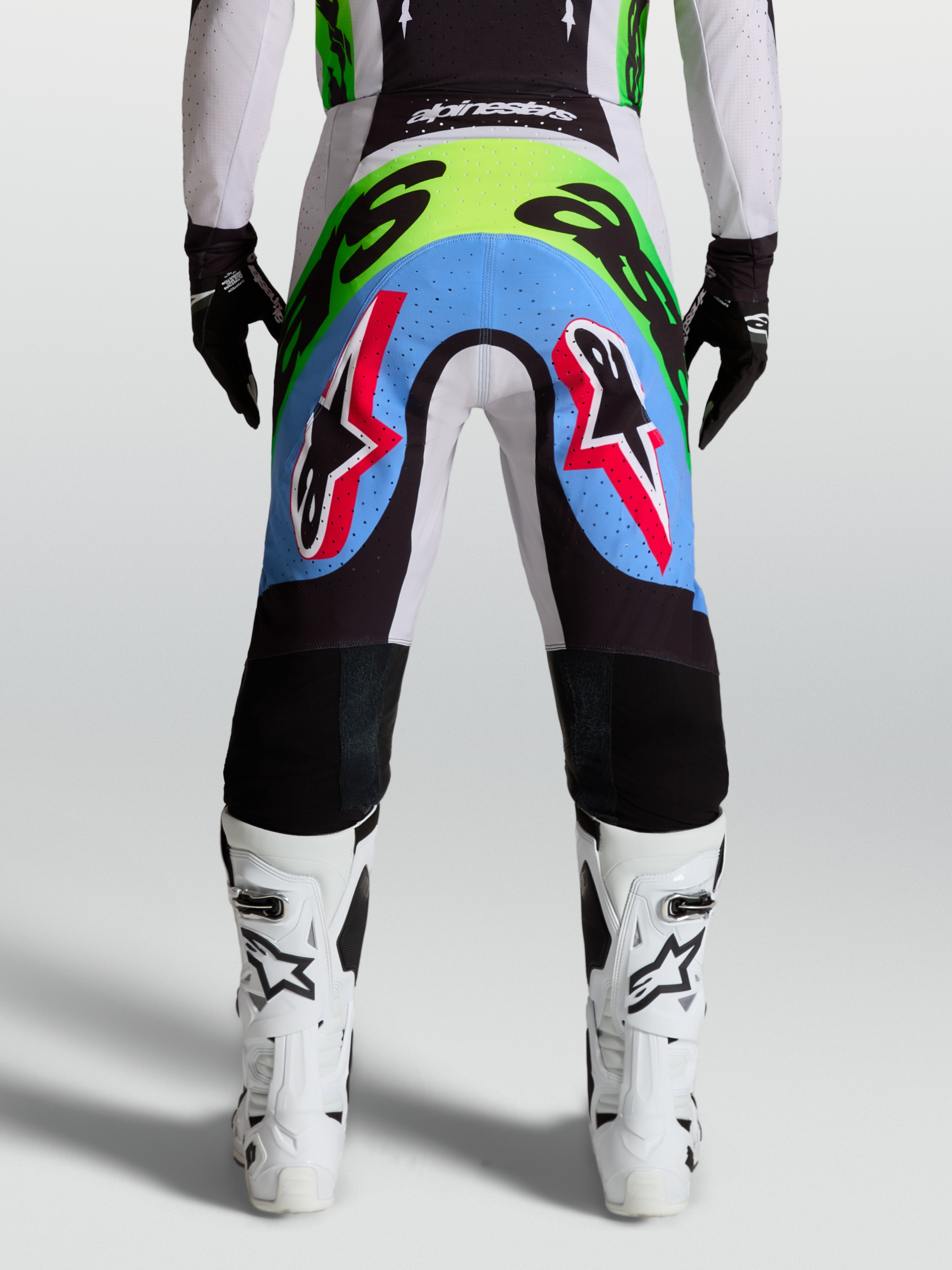 Alpinestars pantaloni Supertech Dyna, pantaloni da motocross da uomo, lilla chiaro e verde fluo, vista posteriore con pannelli elasticizzati traforati