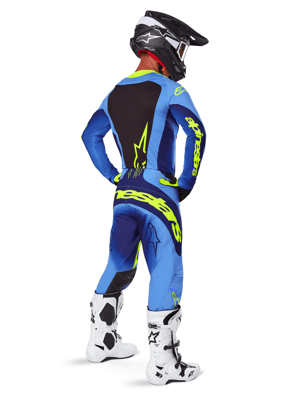Alpinestars 2025 Techstar Melt Pants, equipaggiamento da motocross, Giallo Fluo Blu, vista posteriore del pilota che indossa una maglia blu coordinata con grande logo giallo, stivali bianchi e neri e casco nero, completo da gara coordinato per prestazioni fuoristrada