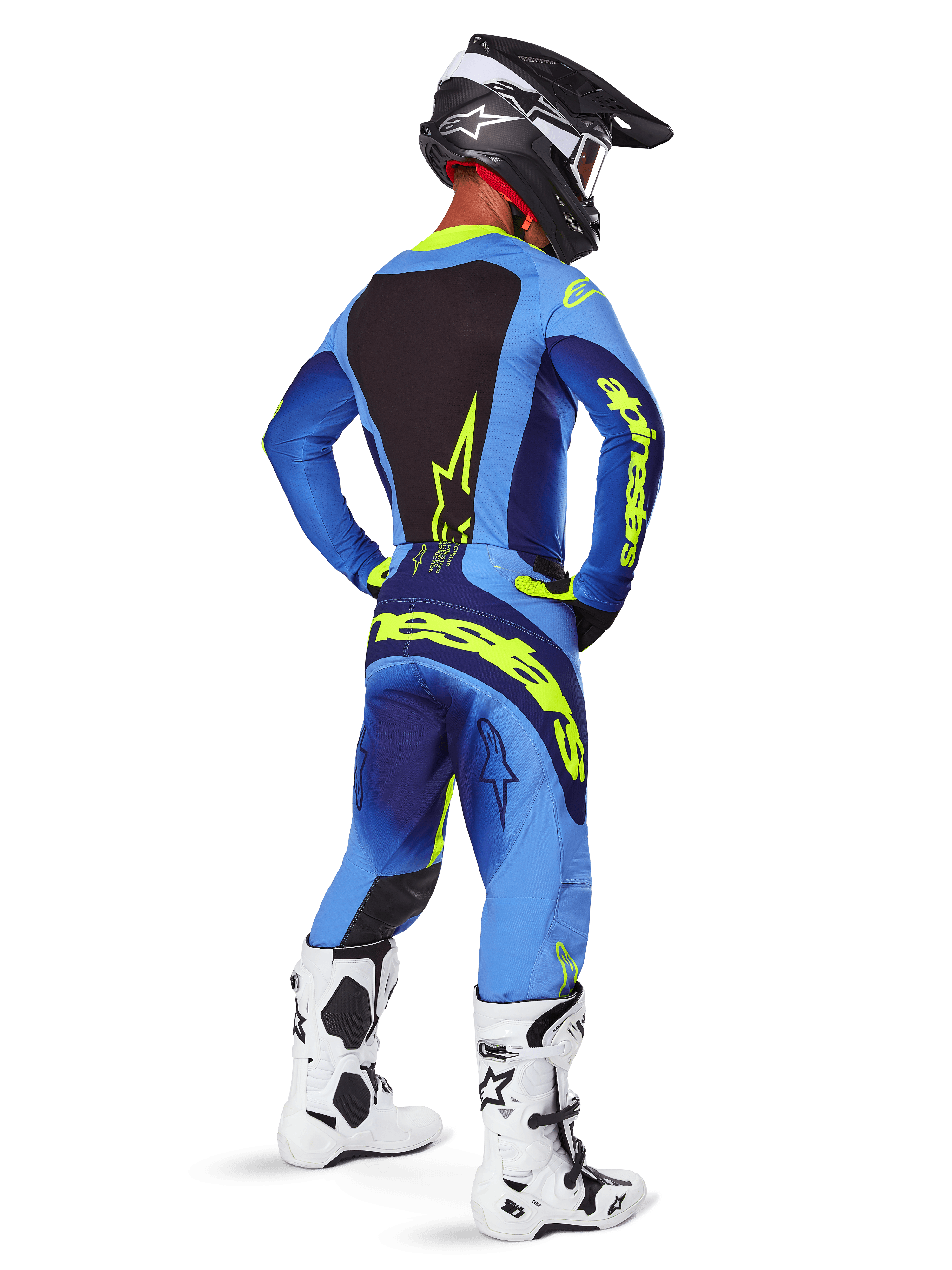 Alpinestars 2025 Techstar Melt Pants, equipaggiamento da motocross, Giallo Fluo Blu, vista posteriore del pilota che indossa una maglia blu coordinata con grande logo giallo, stivali bianchi e neri e casco nero, completo da gara coordinato per prestazioni fuoristrada
