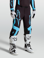 Alpinestars Pantaloni Supertech Vesta, pantaloni da motocross per uomo, neri e turchesi, in tessuto rip-stop elasticizzato con pannelli in pelle di capra, vestibilità atletica da gara per prestazioni pro-level in off-road.