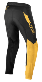 Alpinestars Pantaloni Supertech Blaze, pantaloni da motocross, nero e giallo caldo, vista laterale posteriore, con vistoso logo 'ASTARS' sull'anca, pannelli gialli sulla gamba e tessuto tecnico elasticizzato per prestazioni fuoristrada