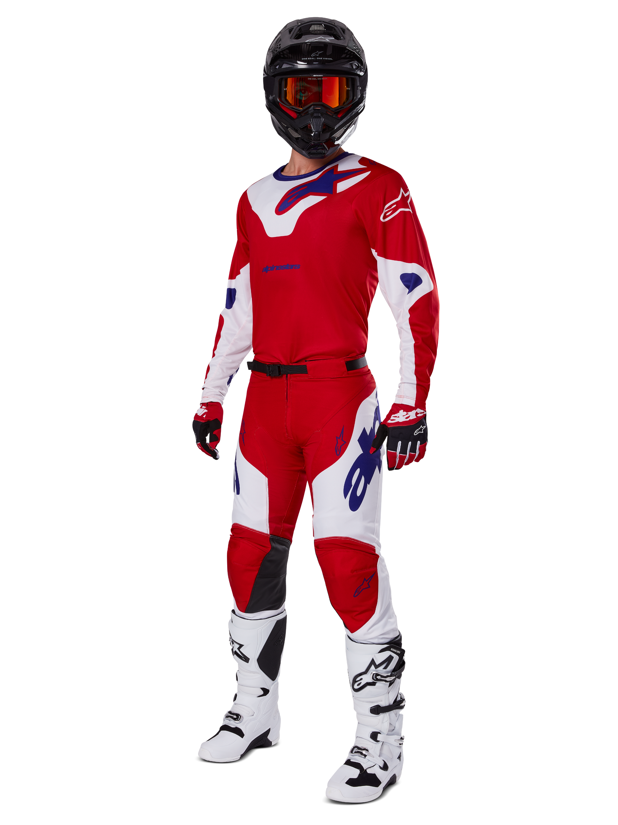 Alpinestars 2025 Racer Veil Pants, pantaloni da motocross, rosso acceso e bianco, indossati come parte di un set completo da gara con maglia coordinata rossa e bianca, casco nero con occhiali arancioni, stivali bianchi e guanti rossi, con loghi Alpinestars blu vivace.