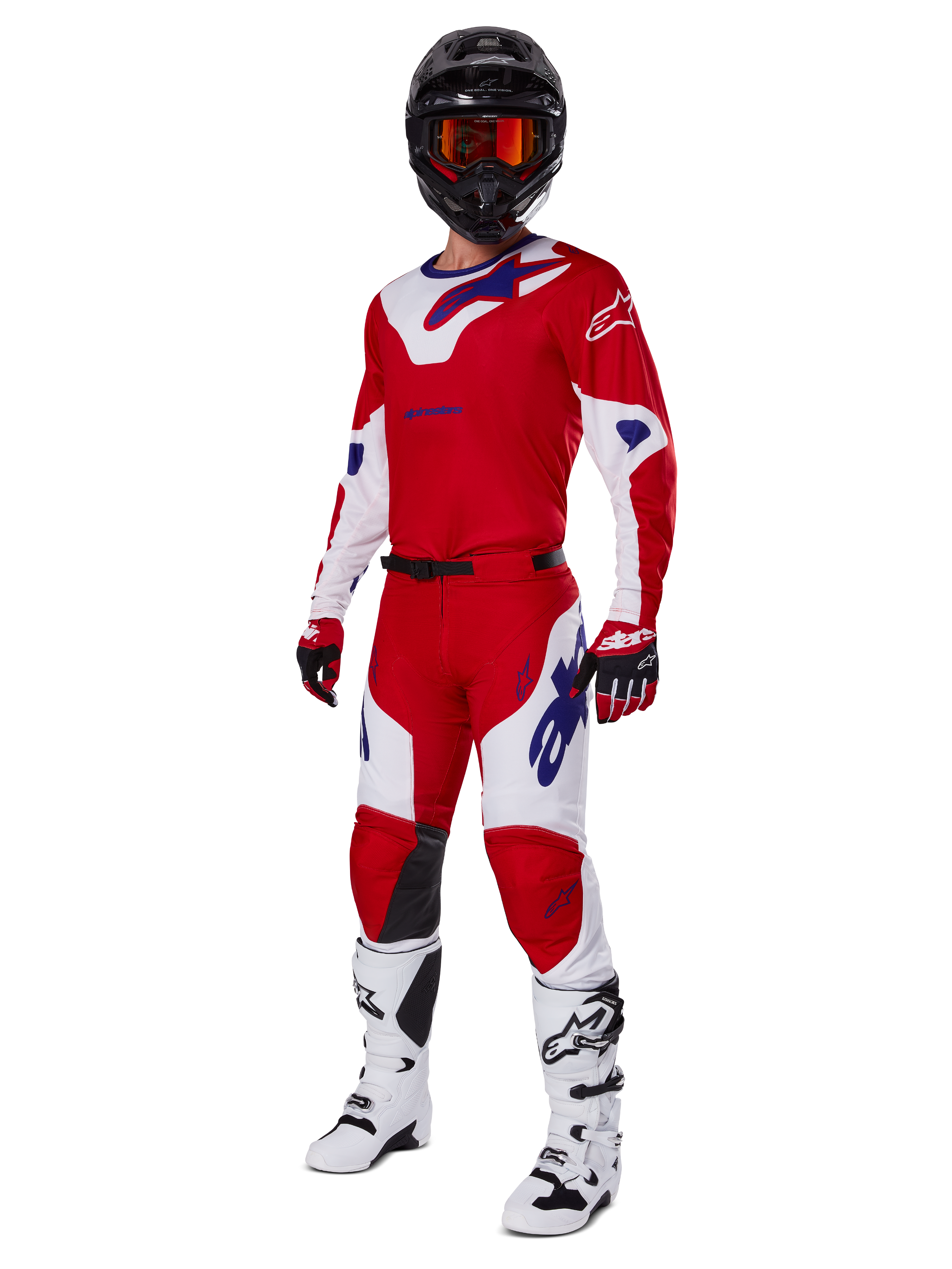 Alpinestars 2025 Racer Veil Pants, pantaloni da motocross, rosso acceso e bianco, indossati come parte di un set completo da gara con maglia coordinata rossa e bianca, casco nero con occhiali arancioni, stivali bianchi e guanti rossi, con loghi Alpinestars blu vivace.