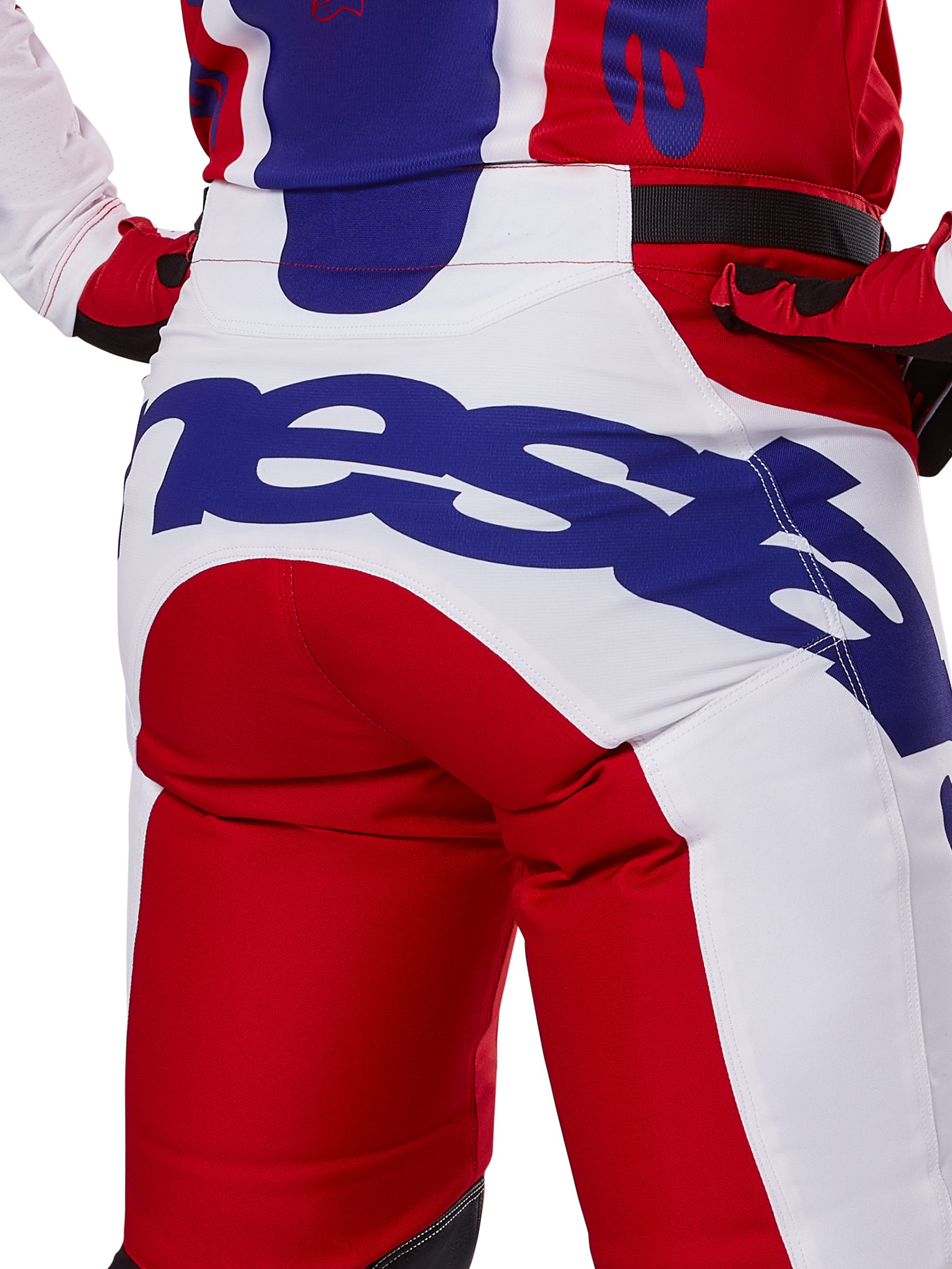 Alpinestars 2025 Racer Veil Pants, pantaloni da motocross, rosso brillante e bianco con branding blu, dettaglio posteriore della zona della seduta con grande logo Alpinestars, indossati come parte di un completo coordinato