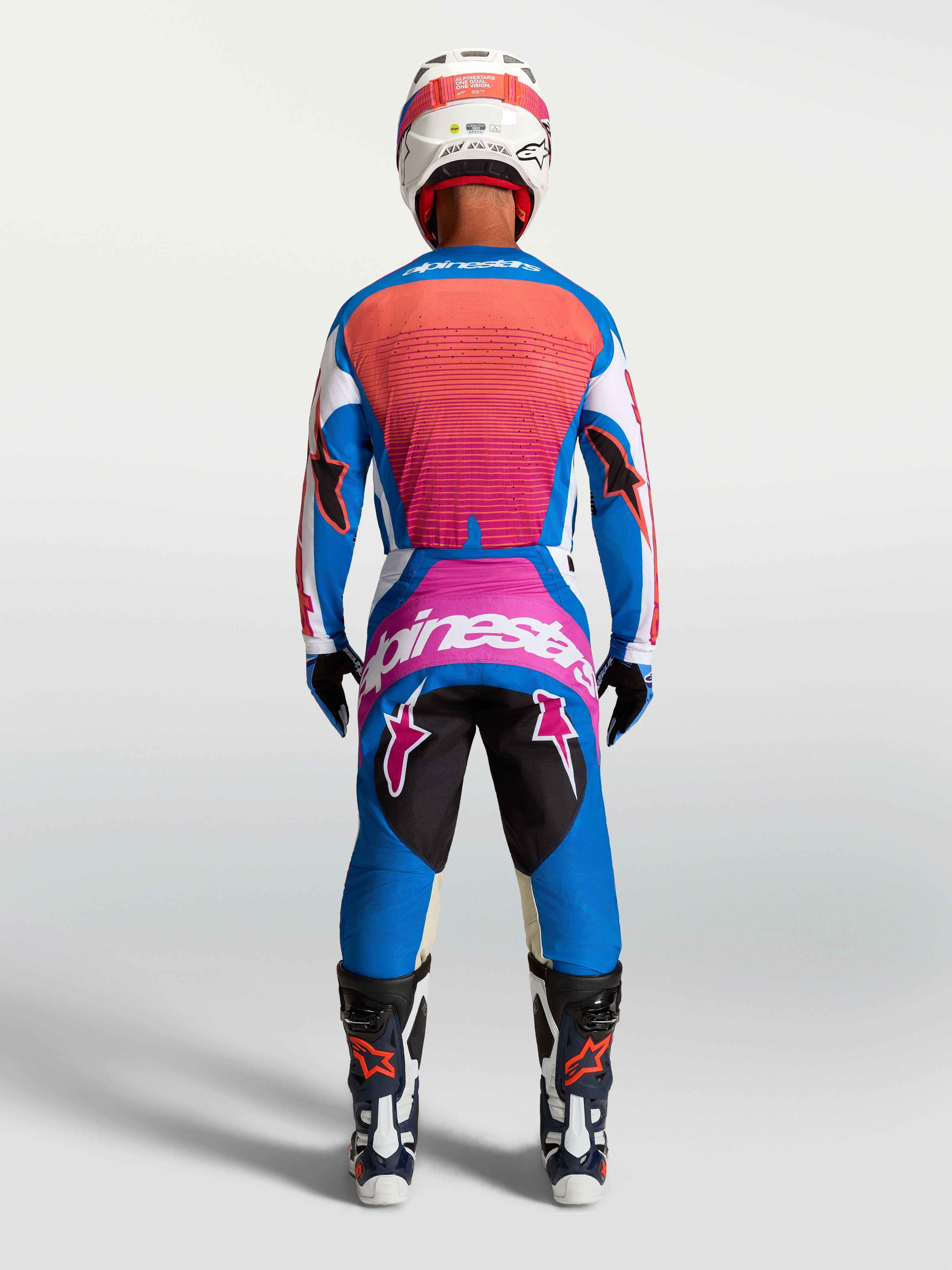 Alpinestars Pantaloni Techstar Maven, pantaloni motocross da uomo, blu e corallo, vista posteriore in assetto da gara.