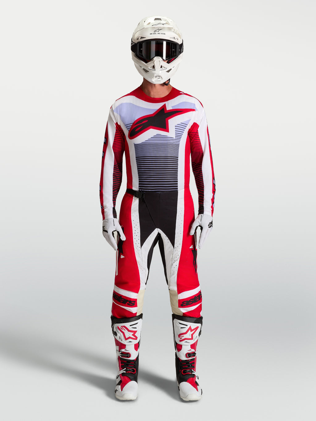 Alpinestars Pantaloni Techstar Maven e completo da motocross uomo, rosso fuoco e bianco, accenti lavanda e stivali abbinati.